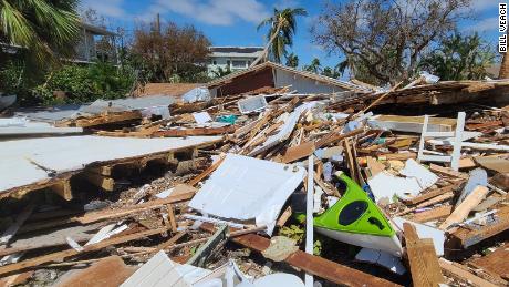 Debris lies around Bill Veach&#39;s badly damaged home in Fort Myers Beach.
