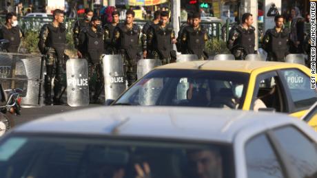 Iran&#39;s riot police forces stand in a street in Tehran.