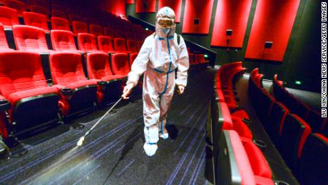A worker wearing personal protective equipment disinfects a cinema on August 9 in Urumqi, Xinjiang, China. 