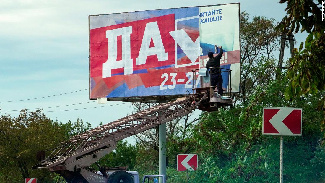 A man glues a &lt;a href=&quot;https://edition.cnn.com/2022/09/29/europe/annexation-russia-ukraine-analysis-intl/index.html&quot; target=&quot;_blank&quot;&gt;referendum&lt;/a&gt; poster reading &quot;Yes&quot; in Berdyansk, Ukraine, on September 26. Russia is attempting to annex up to 18% of Ukrainian territory, with President Vladimir Putin expected to host a ceremony in the Kremlin to declare four occupied Ukrainian territories part of Russia.