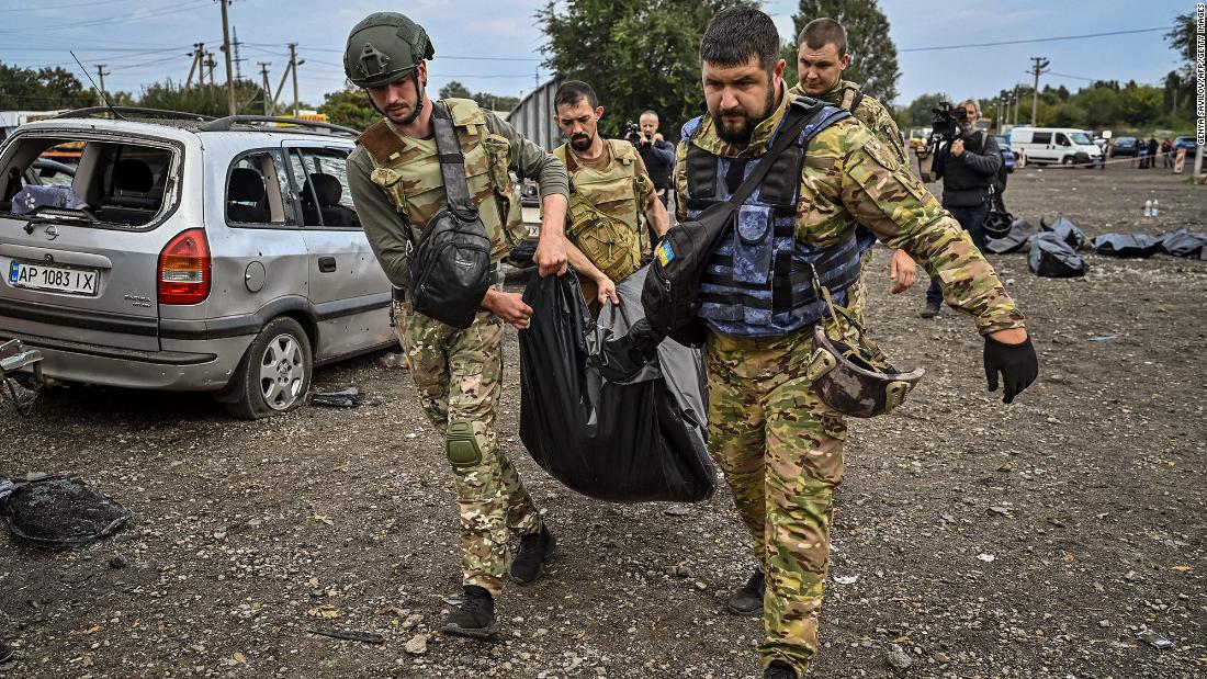 Ukrainian servicemen carry a body bag at the site of a missile &lt;a href=&quot;https://edition.cnn.com/europe/live-news/russia-ukraine-war-news-09-30-22/h_7b936e41381bad5f5e4f54e10972f15a&quot; target=&quot;_blank&quot;&gt;strike on a convoy of civilian cars&lt;/a&gt; that killed at least 30 people near Zaporizhzhia, Ukraine, on September 30.