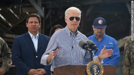 US President Joe Biden speaks in a neighborhood impacted by Hurricane Ian at Fishermans Pass in Fort Myers, Florida, on October 5, 2022 as Florida Governor Ron DeSantis looks on. (Photo by OLIVIER DOULIERY / AFP) (Photo by OLIVIER DOULIERY/AFP via Getty Images)