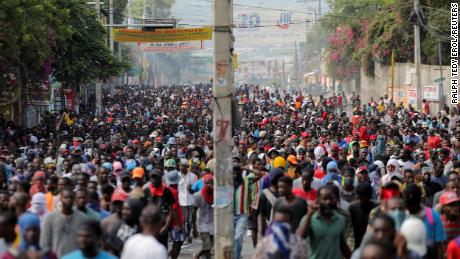 People march in Port-au-Prince, Haiti, on October 3, 2022, during a protest against the government and rising fuel prices.