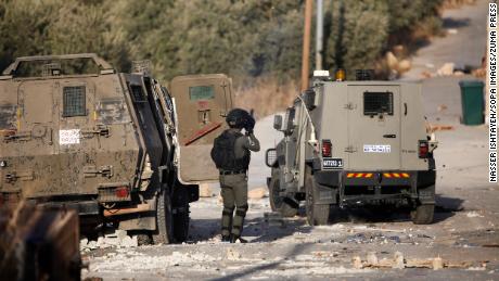 Palestinian youths and Israeli forces clash as troops surround a building in the village of Deir al-Hatab, east of Nablus in the West Bank.