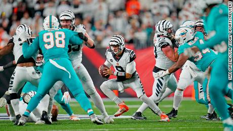 Burrow runs with the ball in the second quarter against the Miami Dolphins.