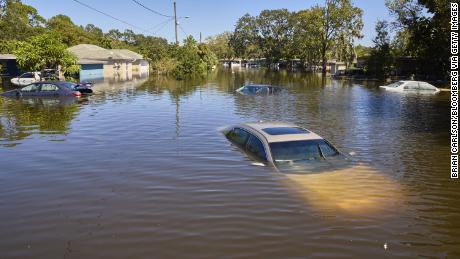 Vehicles and homes submerged in water in a flooded neighborhood following Hurricane Ian in Orlando, Florida, on September 30, 2022. 
