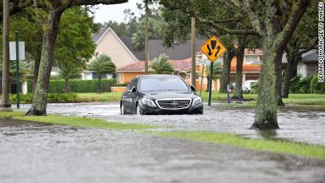A car is seen in a flooded road after being hit by the winds and rain from Hurricane Ian on September 29, 2022 in Sanford, Florida, located in Seminole County.