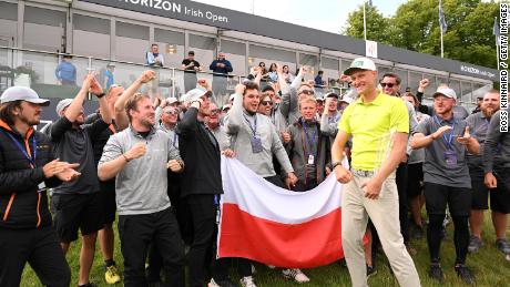 Meronk poses with the Polish flag after his first Tour win.