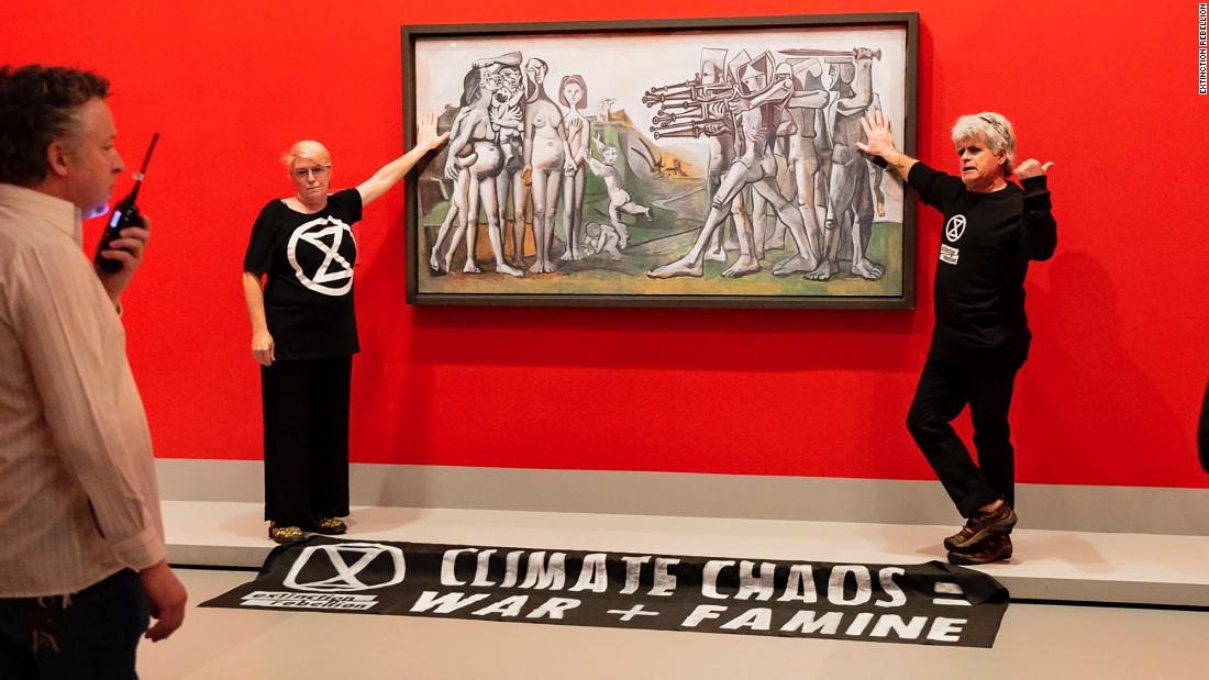 extinction-rebellion-activists-glue-themselves-to-picasso-painting