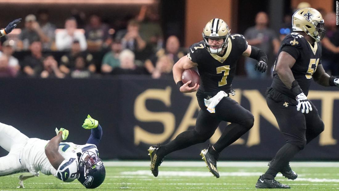 New Orleans Saints utility player Taysom Hill breaks the tackle of Seattle Seahawks safety Quandre Diggs and runs to the endzone for a 60-yard rushing touchdown during the Saints&#39; 39-32 victory. Hill ran for three touchdowns, as well as throwing for another, as the Saints ended a three-game losing streak.