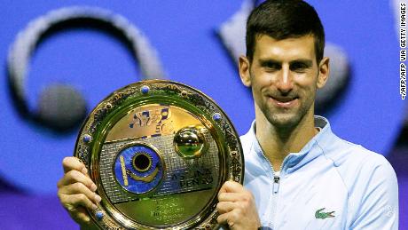 Serbia&#39;s Novak Djokovic celebrates with the trophy after defeating Greece&#39;s Stefanos Tsitsipas in their men&#39;s singles final match at the Astana Open tennis tournament in Astana on October 9, 2022. 