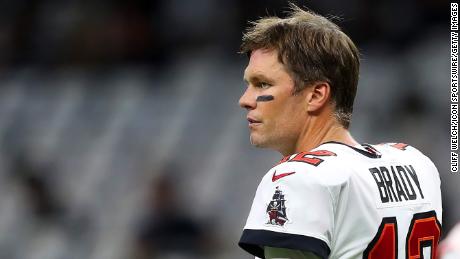 Brady takes his helmet off and looks towards the sidelines during the Tampa Bay Buccaneers vs. New Orleans Saints game on September 18, 2022.
