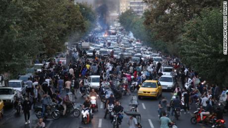 A picture obtained by AFP outside Iran on September 21, 2022, shows Iranian demonstrators in the streets of Tehran during a protest for Mahsa Amini, days after she died in police custody.