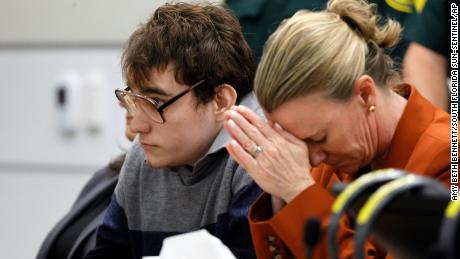 Assistant Public Defender Melisa McNeill, seated with Marjory Stoneman Douglas High School shooter Nikolas Cruz touches her hands to her head as the last of the 17 verdicts were read in the penalty phase of Cruz&#39;s trial at the Broward County Courthouse in Fort Lauderdale, Fla., on Thursday, Oct. 13, 2022.  Cruz will be sentenced to life without parole for the 2018 massacre of 17 people at Parkland&#39;s Marjory Stoneman Douglas High School. That sentence comes after the jury announced Thursday that it could not unanimously agree that Cruz should be executed.