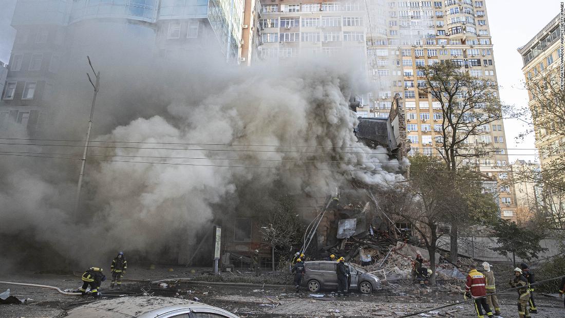 Firefighters work at a destroyed building after Russian drone attacks in Kyiv on Monday.