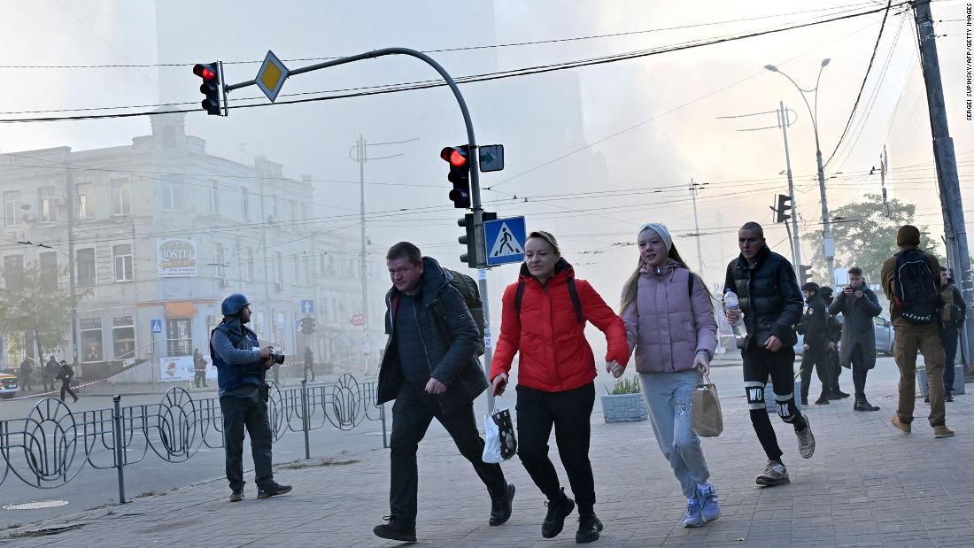 Local residents run away after a drone attack in Kyiv on Monday.