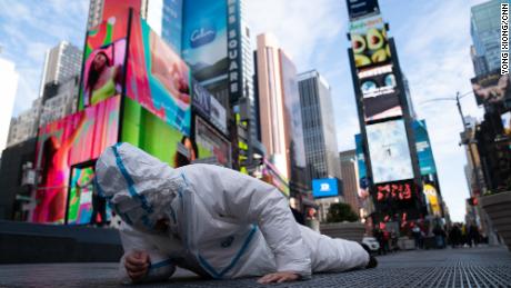 Chinese artist speaks out against zero-Covid policy by wearing 27 hazmat suits in Times Square
