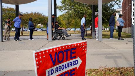 A line of voters stretches outside the building as early voting begins for the midterm elections in Columbus, Georgia, on October 17, 2022.