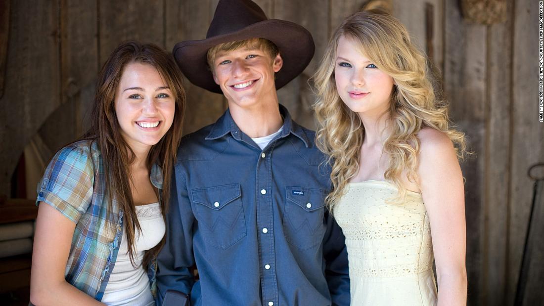 Swift poses for a photo with Miley Cyrus and Lucas Till during filming for &quot;Hannah Montana: The Movie&quot; in 2009. In addition to her musical career, Swift has appeared in a handful of movies through the years.