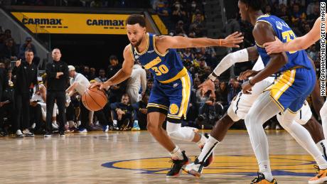 Curry dribbles the ball against the Denver Nuggets at Chase Center in San Francisco, California. 