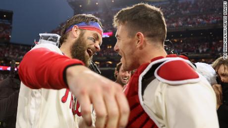 Bryce Harper of the Philadelphia Phillies celebrates with J.T. Realmuto after defeating the San Diego Padres in Game 5 to win the National League Championship Series on October 23, 2022 in Philadelphia.