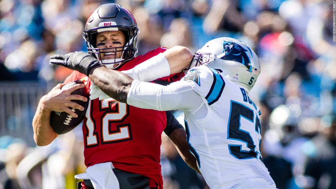 It was tough times for the Tampa Bay Buccaneers and Tom Brady on Sunday against the Carolina Panthers. Brady — sacked here by Panthers defensive end Brian Burns — and the Bucs failed to score a touchdown in a 21-3 loss to Carolina to send Tampa Bay to 3-4 on the year. Despite the loss, the Bucs are still first place in the lowly NFC South.