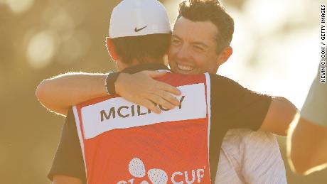 McIlroy embraces caddie Harry Diamond after his win.