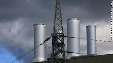 An electricity tower next to chimneys at a natural gas power plant in Brandenburg, Germany. A new UN report shows the world is still over-investing in fossil fuels as global temperatures rise. 