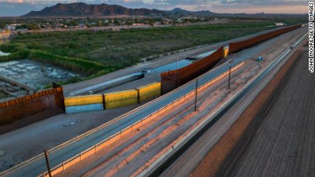 This aerial photo taken September 27 shows shipping containers filling a gap in the US-Mexico border wall in Yuma, Arizona. 