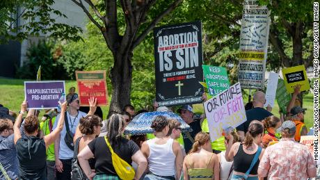 Thousands march and rally in St. Paul, Minnesota on July 17, 2022 in support of legal abortion access after the US Supreme Court overturned the federal constitutional right to an abortion.  Anti- and pro-abortion demonstrators hold up signs showing their different opinions. 
