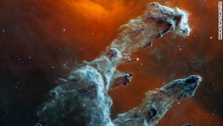 The James Webb Space Telescope captured a new perspective of the Pillars of Creation in mid-infrared light. The dust of this star-forming region is the highlight and resembles ghostly figures.