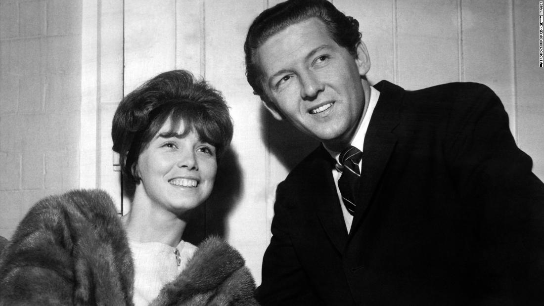 Lewis listens to a show with Myra before entertaining a crowd in 1962.