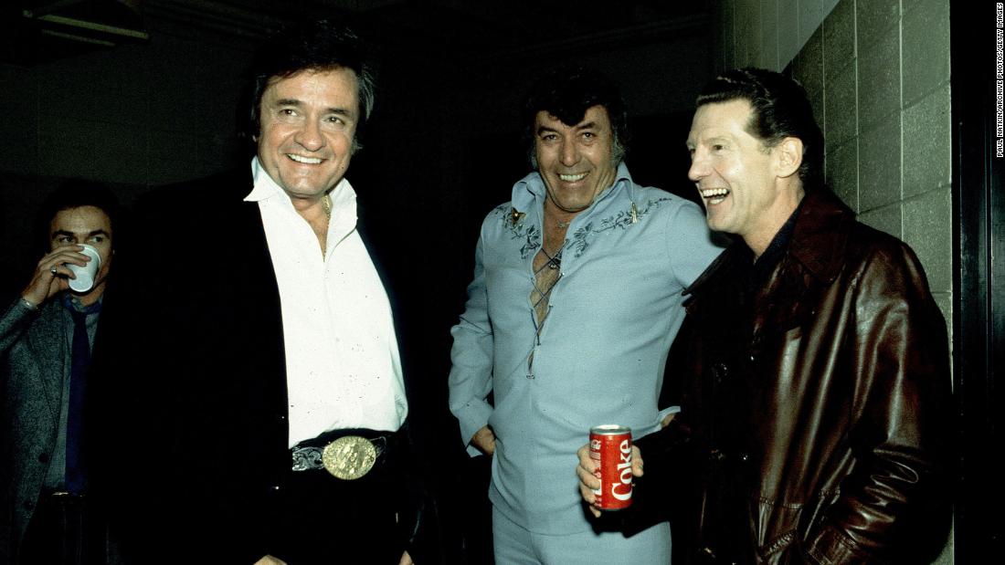 From left, Cash, Perkins and Lewis hang out together at a show in Madison, Wisconsin, in 1982. After a decade of dwindling sales, Lewis reinvented himself in the late 1960s as a country artist and revived his career.