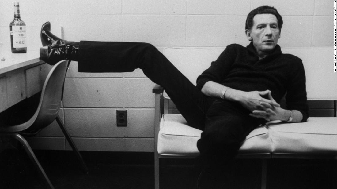 Lewis lounges on a couch inside a dressing room in 1982.