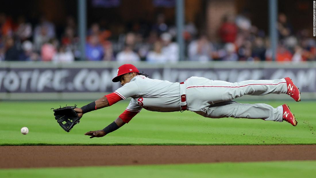 Philadelphia&#39;s Edmundo Sosa dives for a ball but is unable to make the play in Game 2.