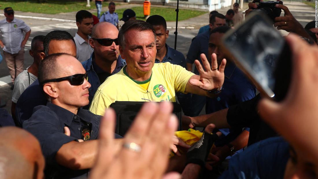 Bolsonaro greets supporters before casting his vote in Rio de Janeiro on October 30.