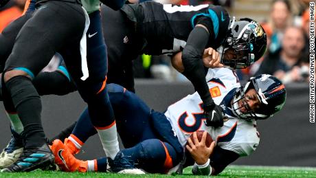 Wilson is sacked by Jacksonville&#39;s Arden Key during the first quarter at Wembley Stadium.