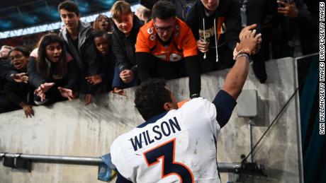 Wilson signs autographs for fans following the Broncos&#39; win over the Jaguars. 