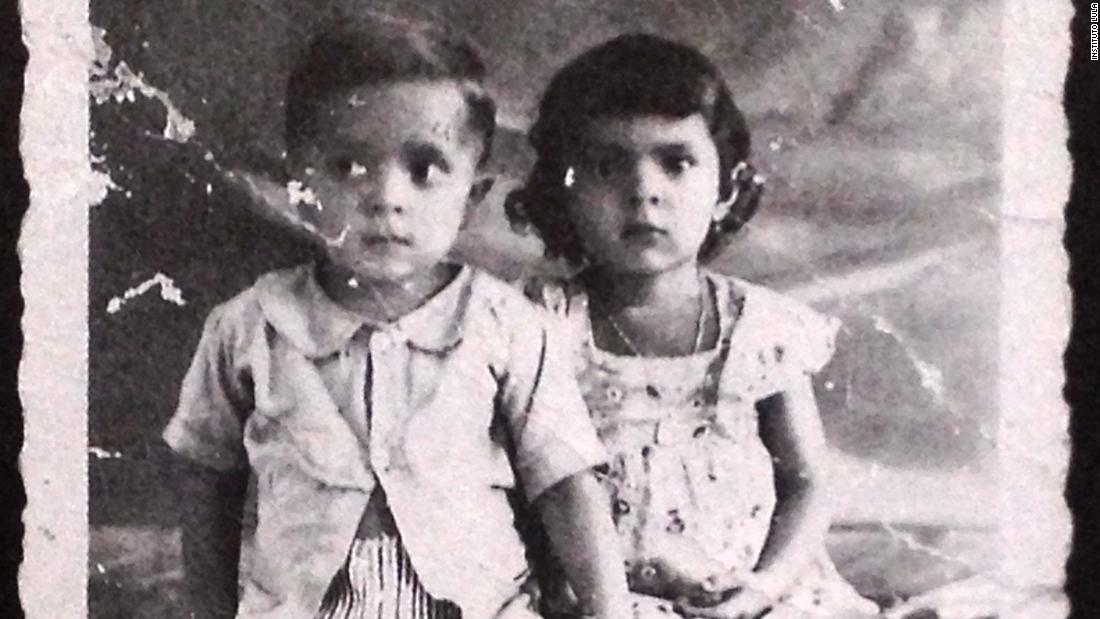 Lula sits for a picture with his sister in 1949.
