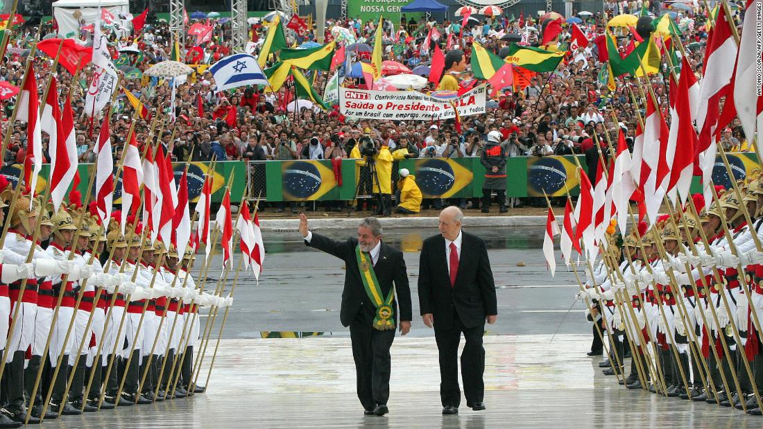 Lula waves as he climbs up the Planalto Palace ramp beside Vice President José Alencar Gomes da Silva during his 2007 inauguration ceremony in Brasília.