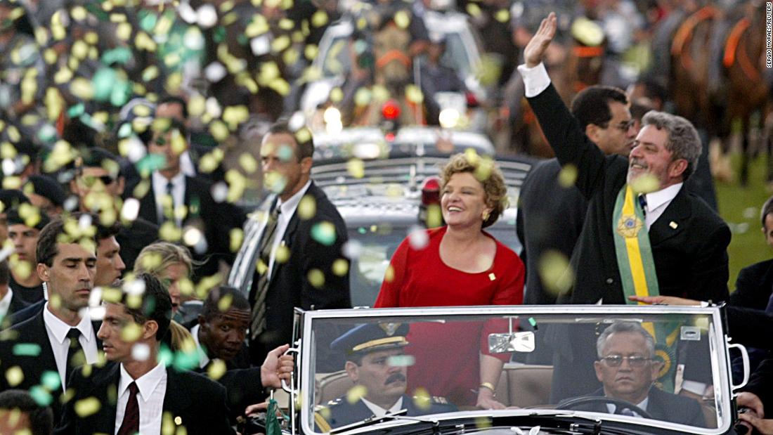 Lula waves to supporters with his wife Marisa after he received the presidential sash at his inauguration in Brasília in 2003.