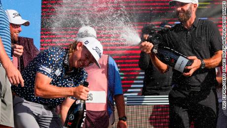Dustin Johnson sprays champagne on Cameron Smith at the LIV Golf Invitational - Miami in October.