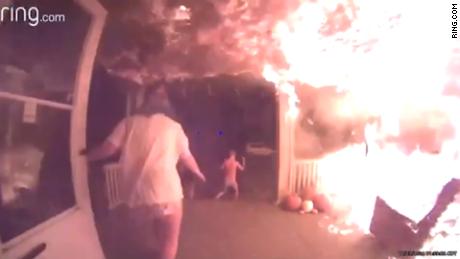 Video doorbell footage shows flames spreading across the porch of a home in Red Oak, Iowa on October 23 as occupants of the house run into the yard.