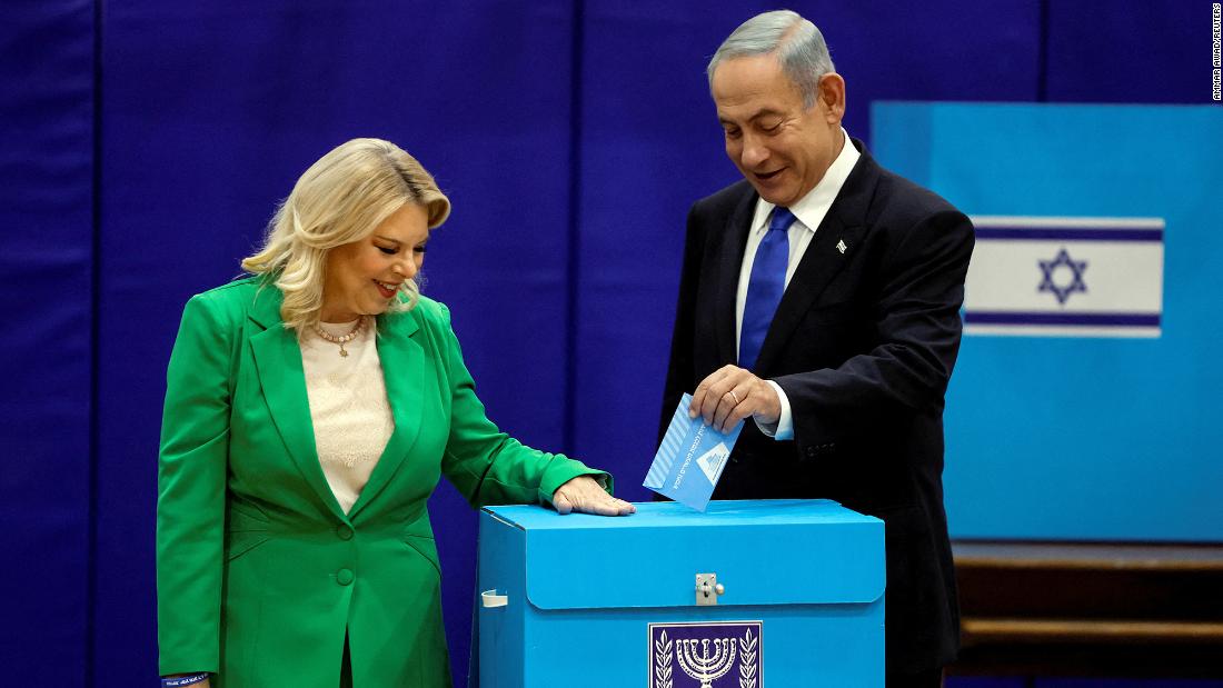 Netanyahu, accompanied by his wife, Sara, casts his ballot at a polling station in Jerusalem in November 2022.