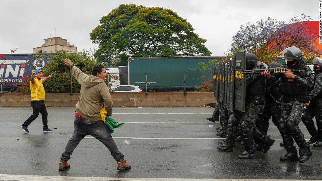 A man argues with riot police as they take position to clear a highway blockade held by supporters of President Jair Bolsonaro on the outskirts of São Paulo on Wednesday November 2.