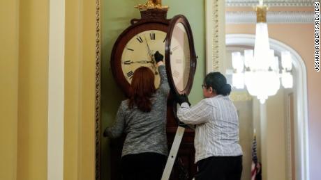 Employees with the Architect of the Capitol wind the Ohio Clock on the first day of the Senate impeachment trial of U.S. President Donald Trump on Capitol Hill in Washington, U.S., January 21, 2020. REUTERS/Joshua Roberts