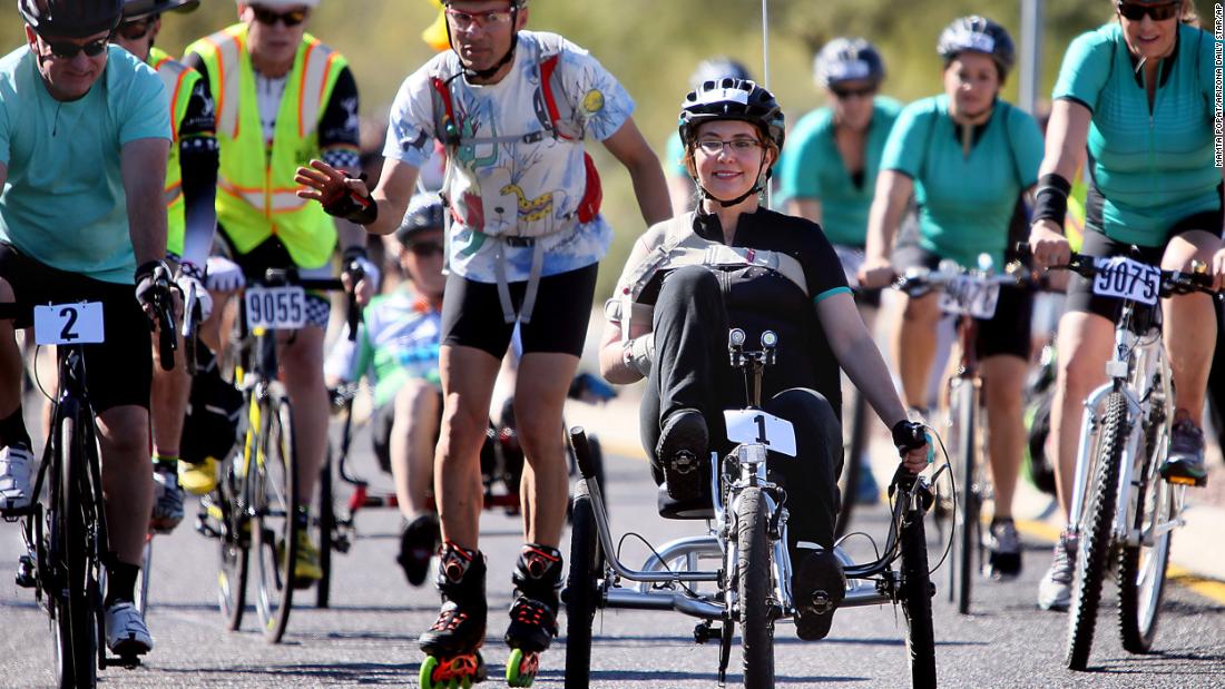 Giffords rides in a charity bike race in Tucson in November 2015.