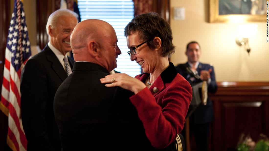 Kelly hugs his wife after he received the Legion of Merit from Vice President Joe Biden, left, during his retirement ceremony in Washington, DC, in October 2011.