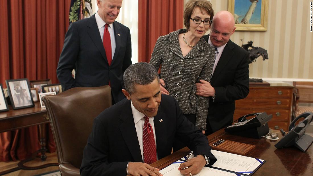 Giffords, Kelly and then-Vice President Joe Biden watch Obama sign the Ultralight Aircraft Smuggling Prevention Act in February 2012. The bill was the last piece of legislation Giffords voted on before she resigned.