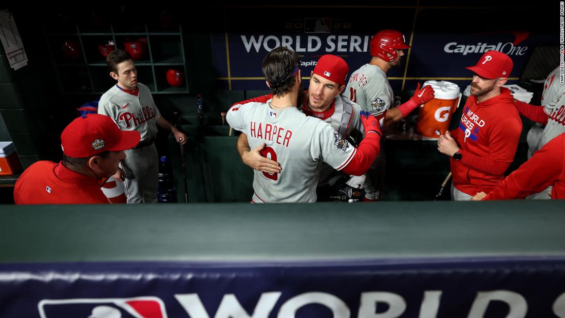 Bryce Harper and J.T. Realmuto of the Philadelphia Phillies get ready in the dugout prior to Game 6.